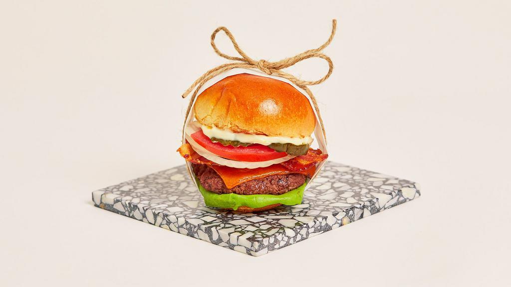 Bacon Cheeseburger Slider · Juicy beef patty with crispy bacon, melted cheddar cheese, lettuce, tomato, onion, pickles, and mayo on a toasted bun.