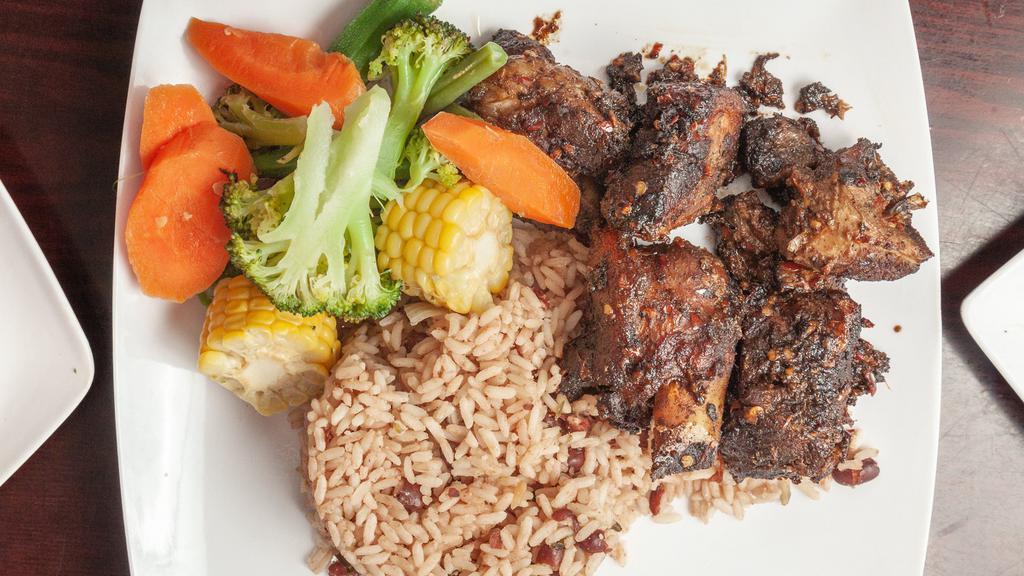 Jerk Chicken · Served with rice and peas, white rice.