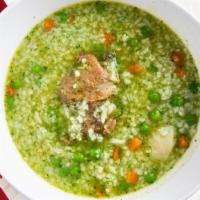 Aguadito · Traditional cilantro chicken soup with rice and peas.