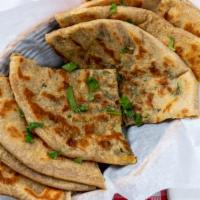 73 Alu Parata · Multilayered whole wheat bread stuffed with potato onion and spices. vegetarian.