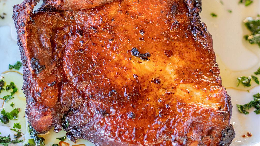 Pork Chops · Tender, Juicy, Seasoned to perfection. Served with Rice & Beans