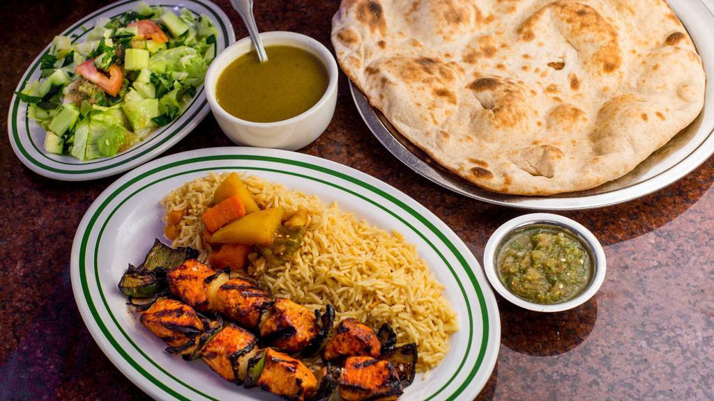 Chicken Kabab · Two Sticks of small chunk of chicken and onions grilled served with vegetables over rice.