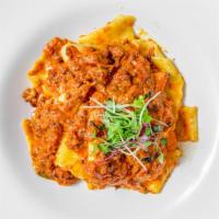 Pappardelle Alla Bolognese · Homemade fresh flat ribbon pasta in a classic
tomato meat sauce with a touch of cream