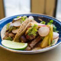 Tacos De Carne Asada · Grilled rib eye served with pico de gallo and avocado
served with rice and beans