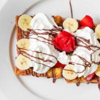 Nutella French Toast · Two challah french toast, hazelnut spread, banana, fresh strawberries, and powdered sugar.