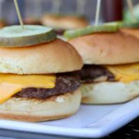 Classic Sliders · Served with sauteed onions, cheese, ketchup, and pickles.