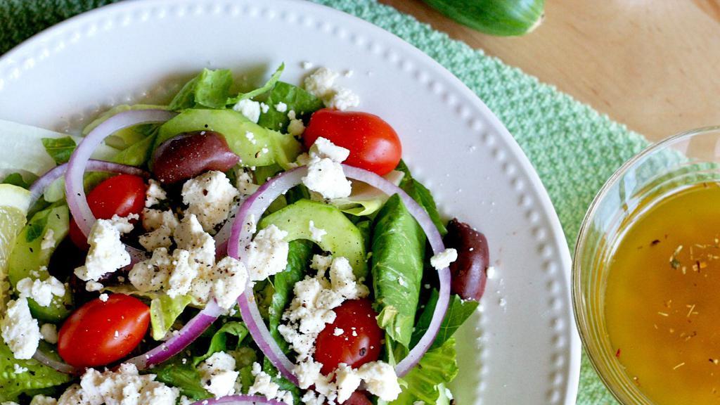 Greek Salad · Mixed greens, tomatoes, cucumbers, Kalamata olives, sliced red onions & crumbled feta cheese with Greek dressing.