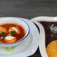 Huevos Ahogados · Two eggs poached in a tomato-chile salsa served with tortillas (five), rice and beans.