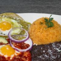 Huevos Divorciados · Two fried eggs divided between red and green sauce served with tortillas (five), rice and be...