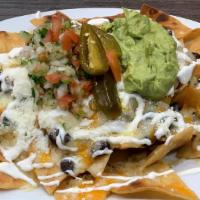 Nachos (Plain) · Tortilla chips with beans, cheddar, Monterey jack cheese topped with guacamole, jalapeños an...