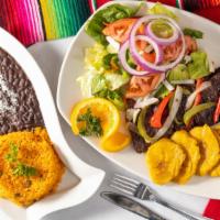 Churrasco · Grilled skirt steak served with rice, beans, salad and tostones.