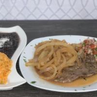 Bistec Encebollado · Mexican-style steak and onions, marinated in olive oil, various spices. Served with rice and...