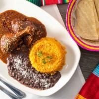 Mole Poblano · Served with rice and beans.