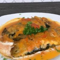 Chiles Rellenos · Roasted poblano chiles stuffed with cheese dipped in an egg, butter and fried.