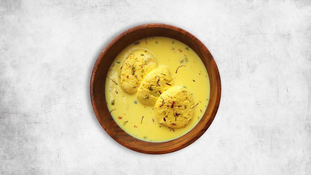 Rasmalai · 2 pieces. Soft cheese patties soaked in milk, cardamom, and sweet water syrup.