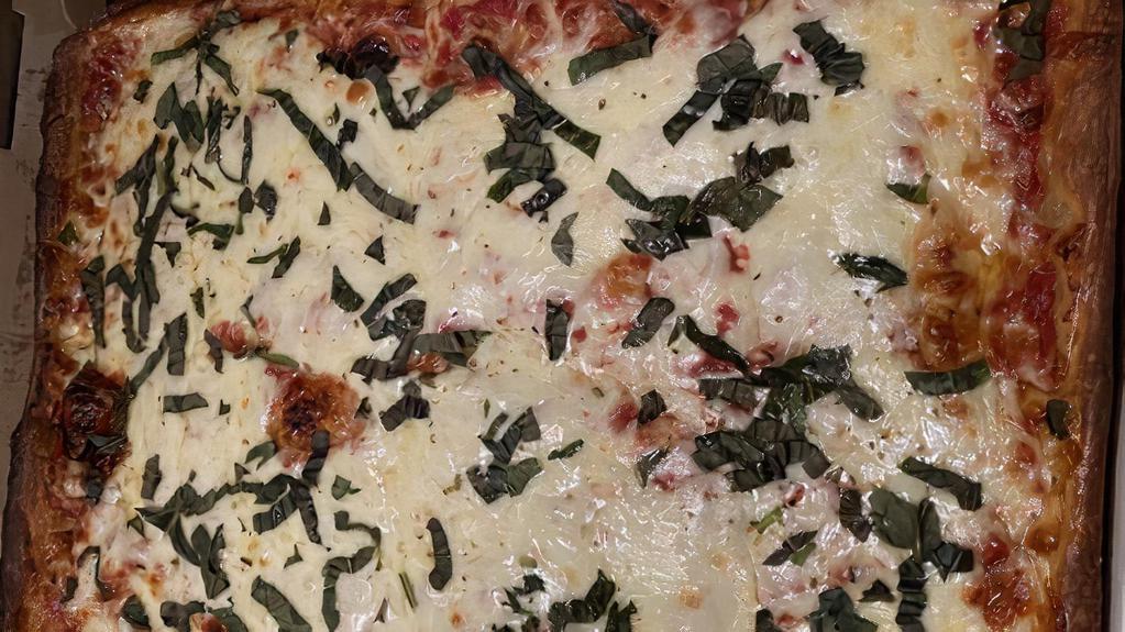 Grandma Squire Sicilian Pizza · Mozzarella, homemade marinara, olive oil, basil, parmigiana-reggiano.