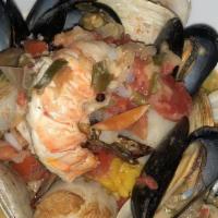 Seafood Paella · Shrimp, lobster meat, scallops, mussels, clams, served over saffron risotto.