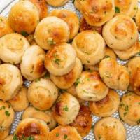 Garlic Knots (6) · Knot Shape Pizza Dough Tossed With Real Butter Garlic Herbs mix