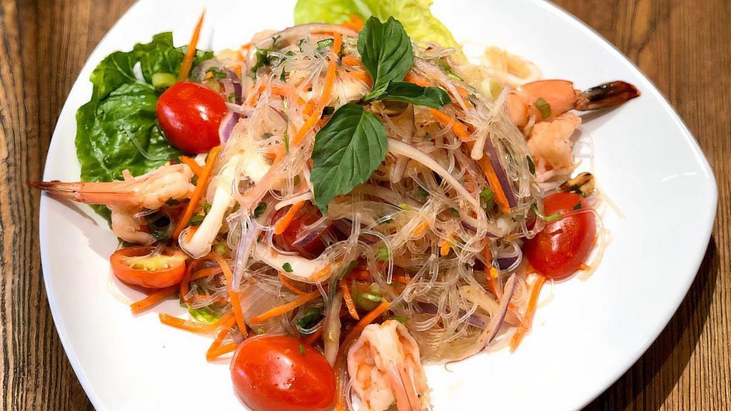 Yum Woon Sen (Glass Noodle Salad) · Calamari, shrimp, red onion, glass noodles, peanut, carrots, scallion, tomatoes, fresh chili w/ Thai lime sauce.