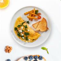 Greek Omelette · Eggs cooked with olives, feta cheese, and cherry tomato as an omelette and served with toast...