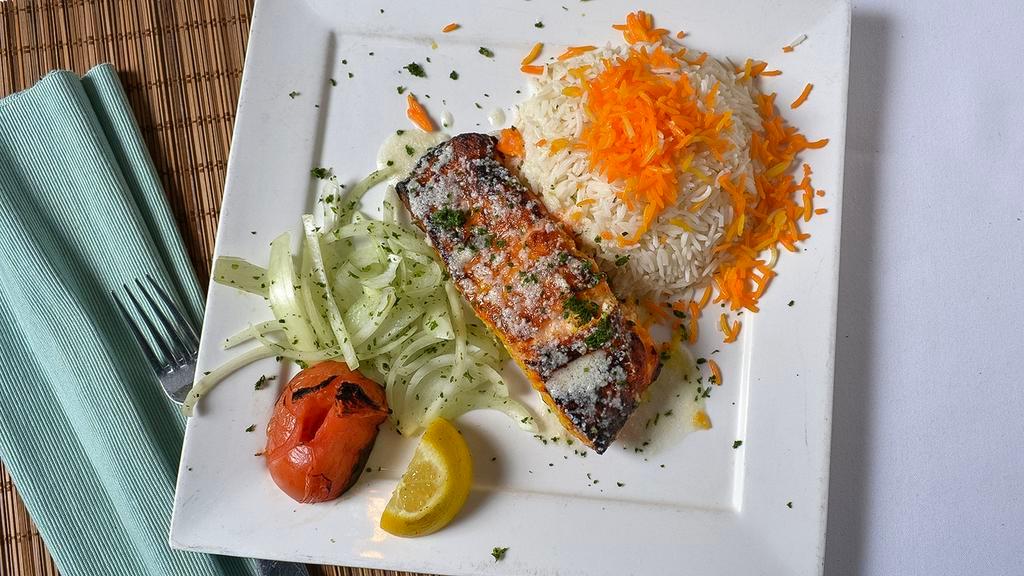 Salmon Steak · Marinated with fresh lemon juice and saffron, grilled and topped with lemon-garlic sauce.