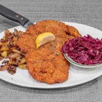 Wiener Schnitzel · Breaded and fried pork cutlet, with lemon wedge on the side, and served with home fried pota...
