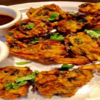 Vegetable Mix Pakora · VEGAN - A mix of cabbage, onions, carrot dipped in gram flour & fried to perfection.