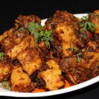 Kodi Vepudu · GLUTEN FREE - Boneless chicken cooked with curry leaves & other spices, sprayed with chili &...