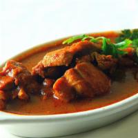 Goat Vindaloo · GLUTEN FREE - Fire-roasted goat mix with chef special vindaloo sauce, potatoes & hint of vin...