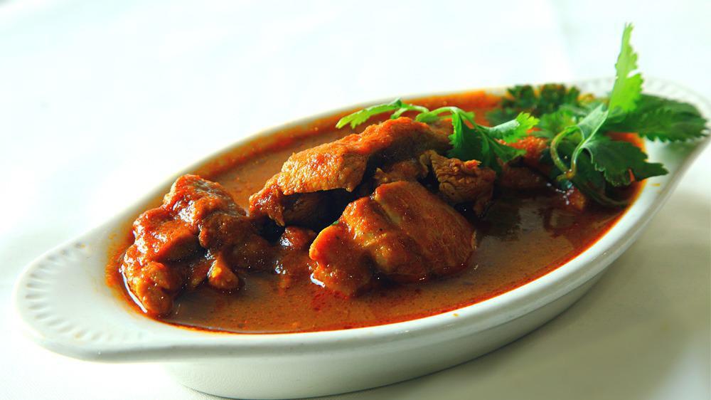 Goat Vindaloo · GLUTEN FREE - Fire-roasted goat mix with chef special vindaloo sauce, potatoes & hint of vinegar.