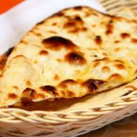 Butter Naan · Made with white flour mix with milk, yeast & salt coated with butter cooked in charcoal (Cla...