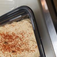 Hummus · Fresh chickpea tahini served with two pita bread.