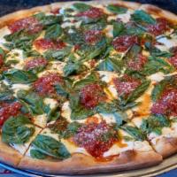 Margarita · Marinara sauce, fresh homemade mozzarella, fresh basil & signature extra virgin olive oil.