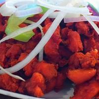Chicken 65 · Boneless chicken cubes are marinated in Indian spices with yogurt and fried to perfection.