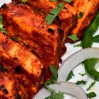 Tandoori Paneer Tikka · Cottage cheese infused with herbs, spices, and yogurt cooked in a Clay oven.