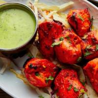 Tandoori Chicken Tikka · Boneless juicy chunks of chicken marinated in aromatic Indian herbs and spice cooked in a cl...