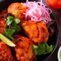 Tandoori Chicken · Chicken on the bone marinated overnight in fresh aromatic Indian spices and herbs cooked in ...
