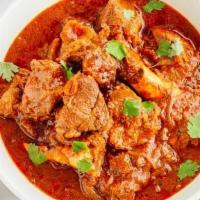 Chozhas Special Goat Curry · Goat meat on the bone cooked with garlic & ginger in a brown sauce with a compound of South ...