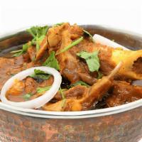 Kadai Goat · Tender pieces of goat (with bone) bell pepper, onion tossed with fresh herbs and spices cook...