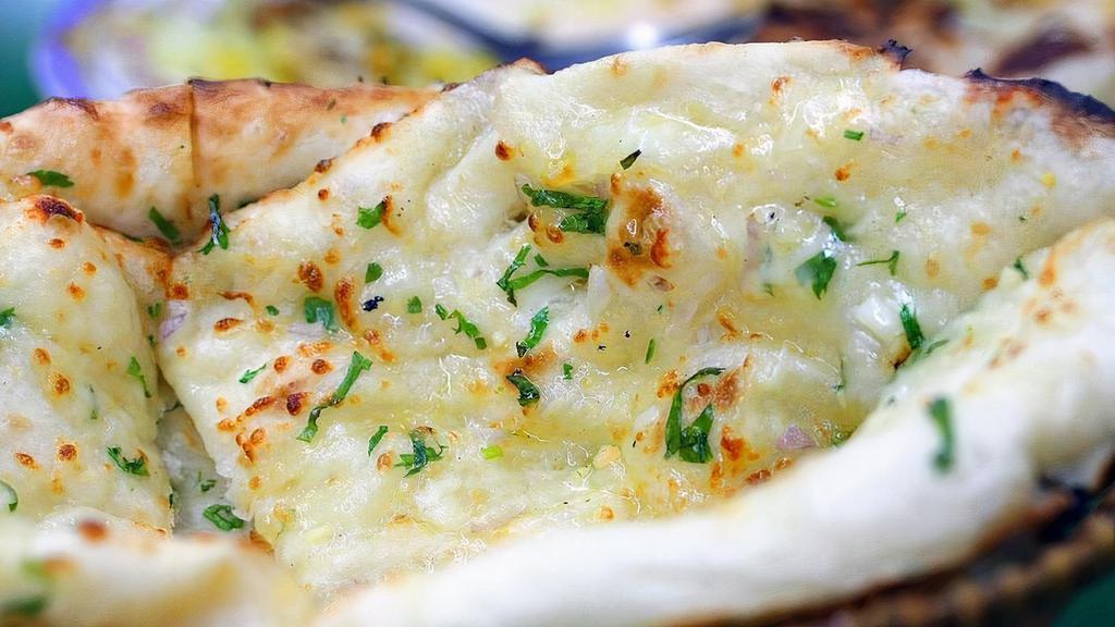 Chili Garlic Naan · Indian bread baked in clay oven topped with chopped chilies and garlic.
