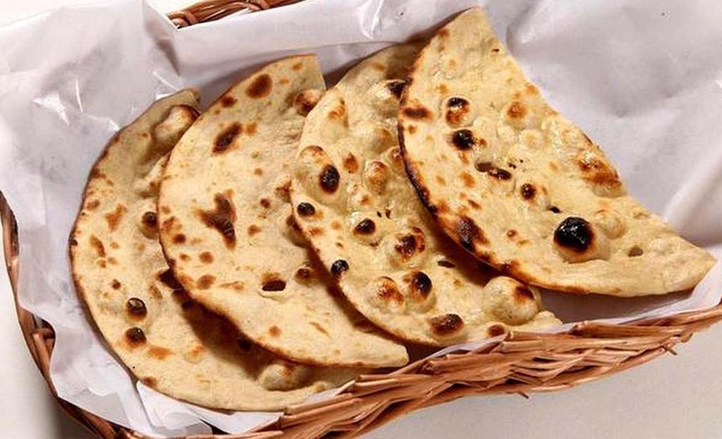 Roti · Traditional Indian wheat bread baked in clay oven with no butter.