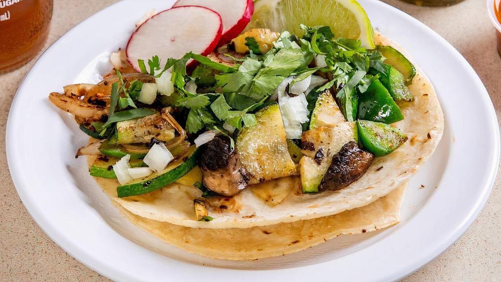 Veggie Taco (Order Of 3) · Grilled green peppers, onions zucchini and portabello mushrooms. Topped with cilantro, onions, lime wedge, radish. Choice of green, red or guacamole sauce.