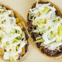 Steak Huarache · A freshly made, thick and soft corn tortilla coated with refried beans, topped with lettuce,...