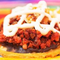 Chorizo Picaditas · A freshly made, thick, and soft corn tortilla coated with refried beans, topped with sour cr...