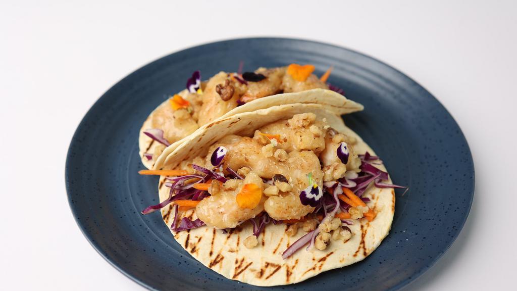 Honey Walnut Shrimp Taco · Lightly battered and fried shrimp tossed in
creamy honey sauce, with candied walnuts, and
cabbage-carrot slaw in flour tortillas