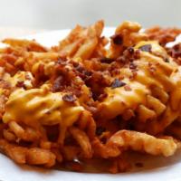 Waffle Fries With Cheese Sauce, Diced Bacon, And Bbq · 