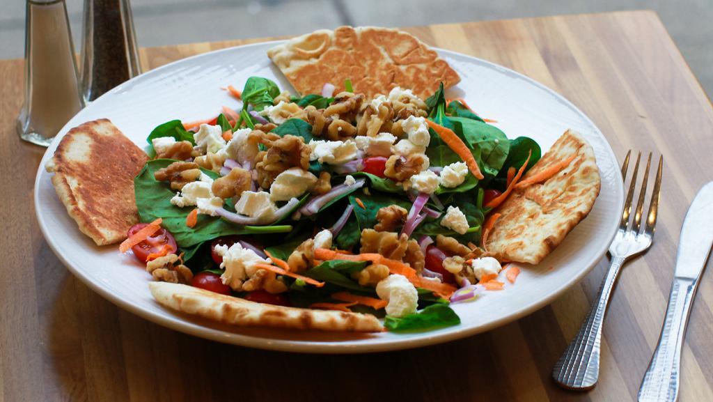 Spinach & Goat Cheese Salad · Fresh baby spinach with red onion goat cheese caramelized walnuts and tomato.