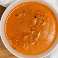 Butter Chicken · Boneless chicken baked and cooked in creamy tomato sauce with butter and spices