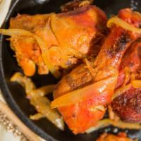 Tandoori Chicken · Chicken marinated in yogurt and mild spices, cooked in its own juices over hot charcoal, roa...