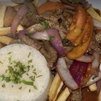 Lomo Saltado · Beef slices fried in onion, tomato served with french fries and rice.